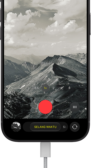 iPhone 18 Pro, eksterior depan, menampilkan lanskap bergunung, dengan overlay mode kamera dalam mode Selang Waktu, dengan kabel daya terpasang ke port pengisian daya