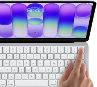 MacBook Neo, warna silver, menampilkan layar masuk, jari seseorang pada sensor Touch ID di sudut kanan atas keyboard